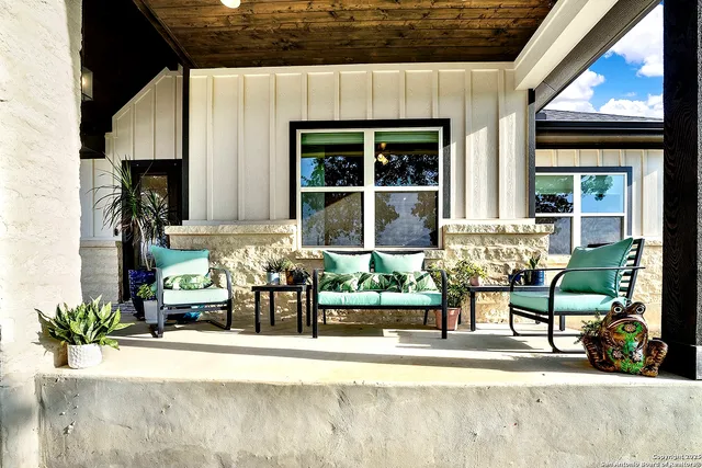 a front view of a house with sitting area