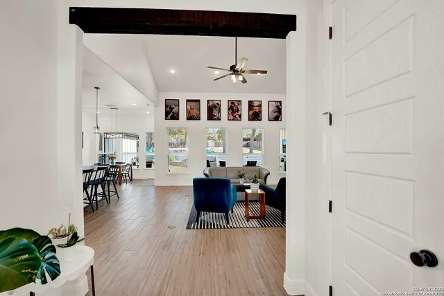 a living room with furniture and wooden floor