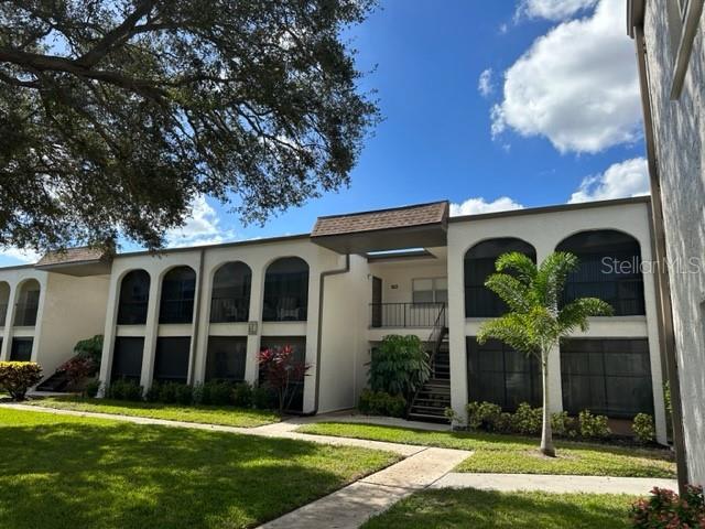 7701 Starkey Road, Unit 731 Seminole, FL 33777 - Photo 1 of 19 a view of a house with yard and porch