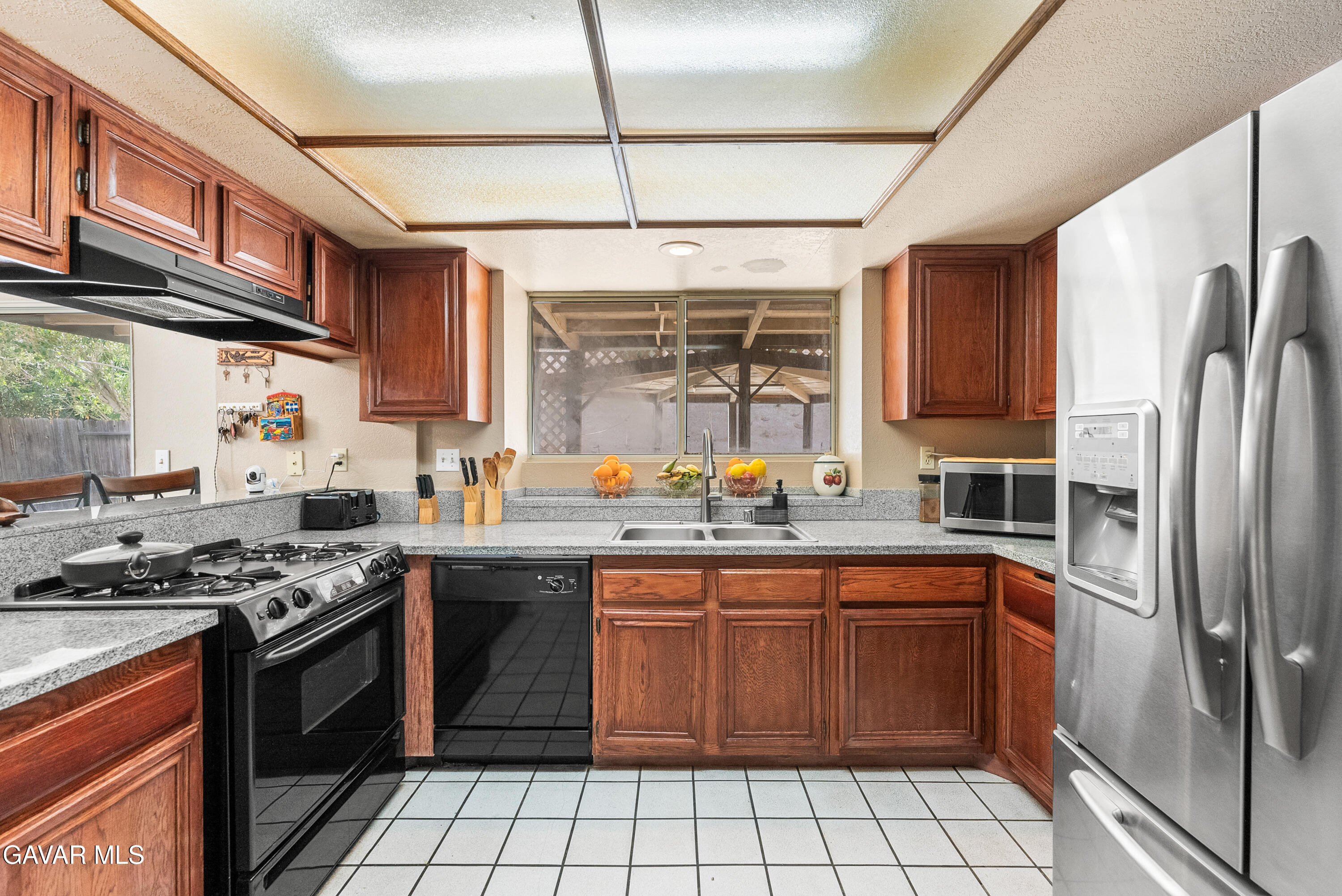 37635 Sandra Lane Palmdale, CA 93550 - Photo 27 of 46 a kitchen with stainless steel appliances granite countertop a stove a sink dishwasher and a refrigerator