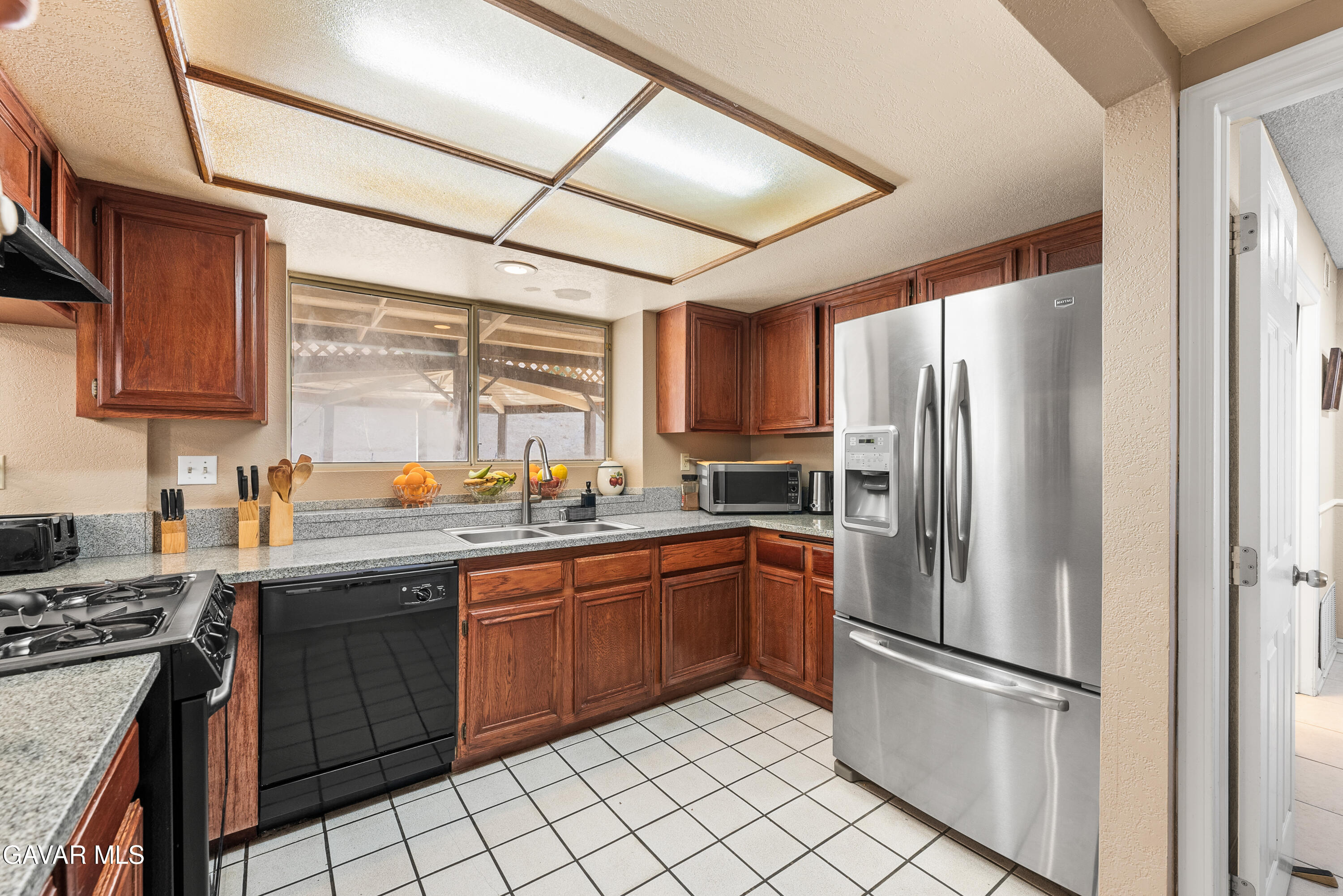 37635 Sandra Lane Palmdale, CA 93550 - Photo 28 of 46 a kitchen with stainless steel appliances granite countertop a refrigerator sink and stove