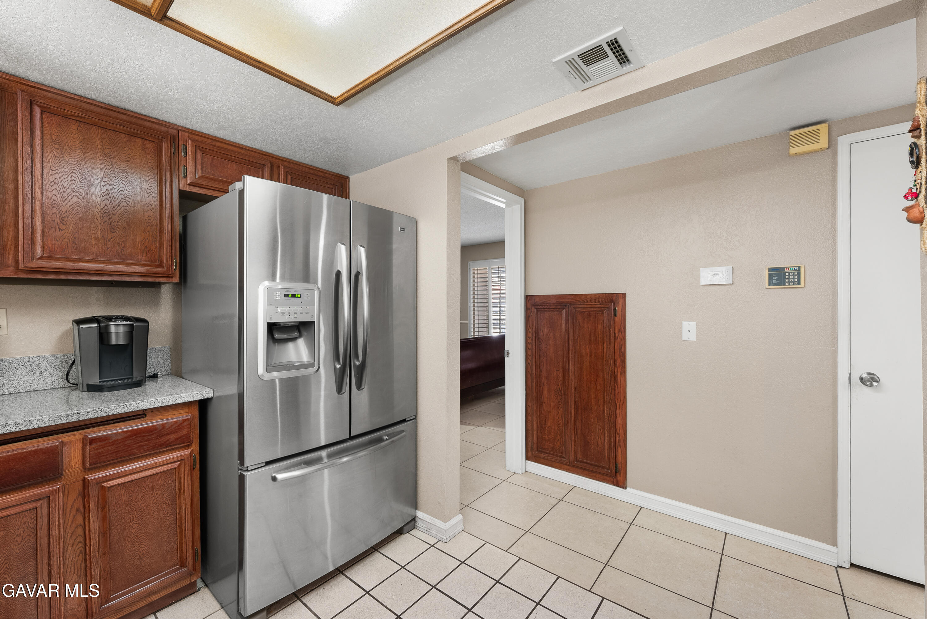 37635 Sandra Lane Palmdale, CA 93550 - Photo 32 of 46 a kitchen with stainless steel appliances granite countertop a refrigerator and a stove top oven