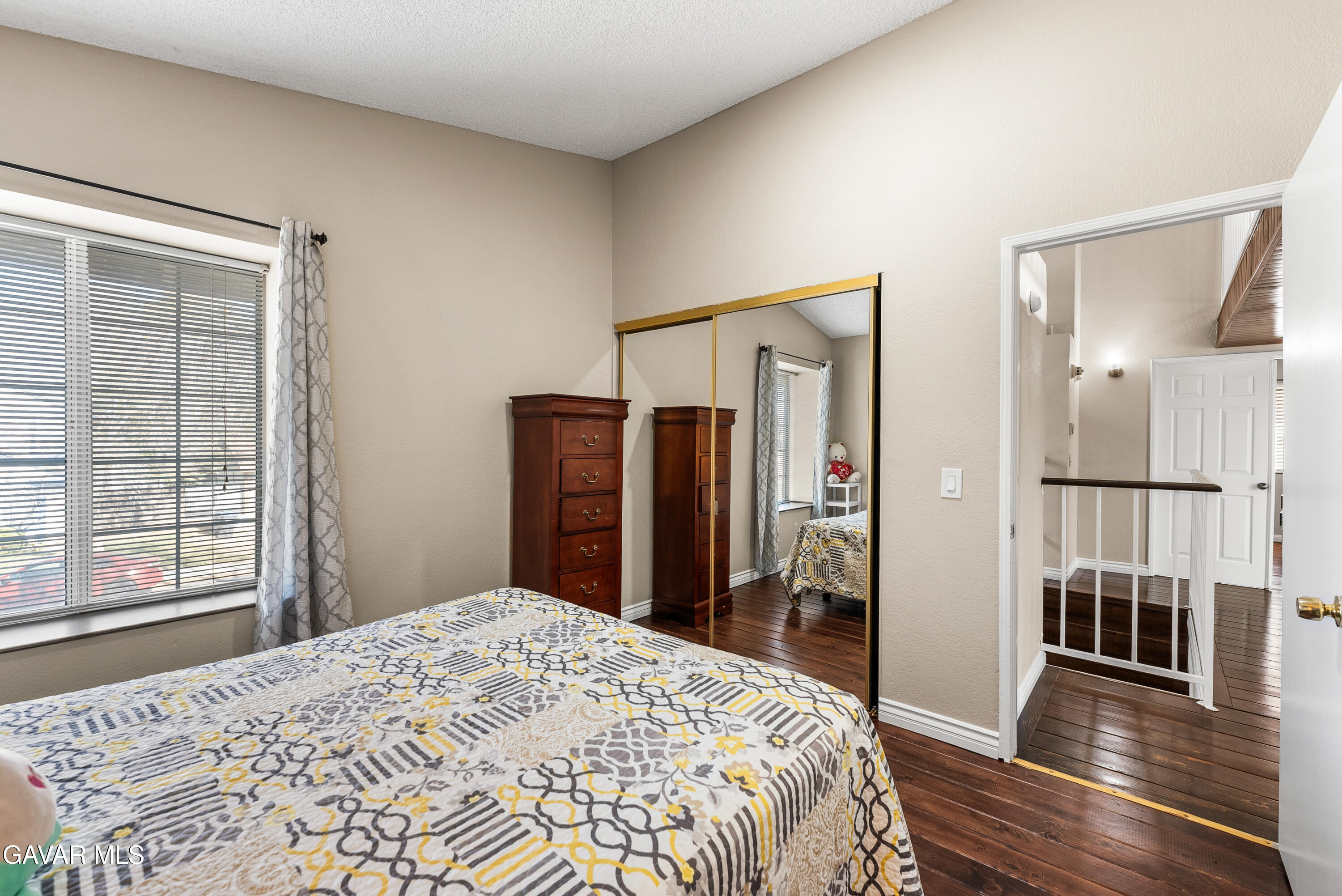 37635 Sandra Lane Palmdale, CA 93550 - Photo 42 of 46 a bedroom with a bed closet and wooden floor