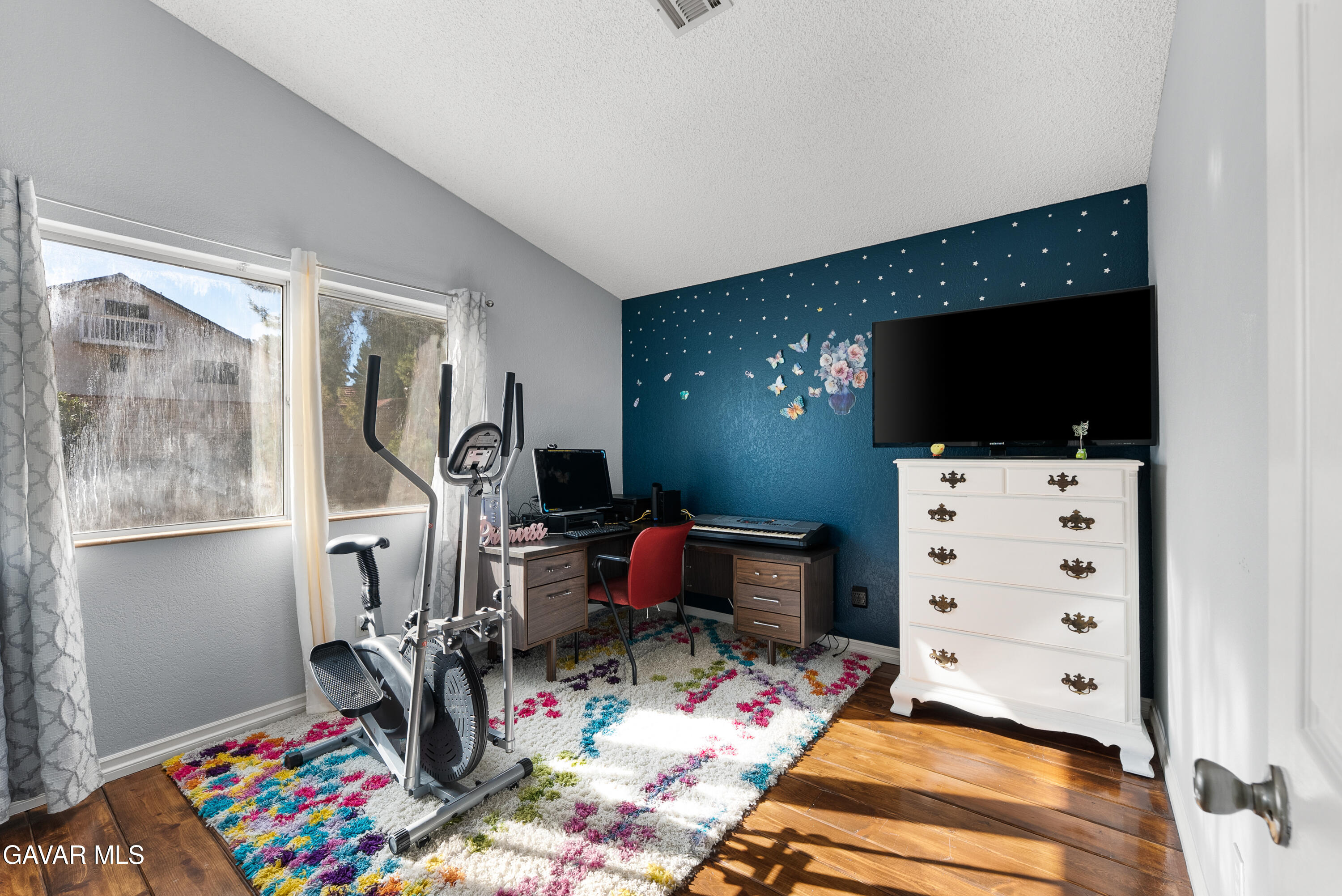 37635 Sandra Lane Palmdale, CA 93550 - Photo 43 of 46 a room with furniture a flat screen tv and a view of kitchen