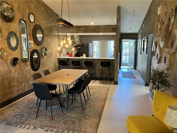 a dining room with furniture and wooden floor