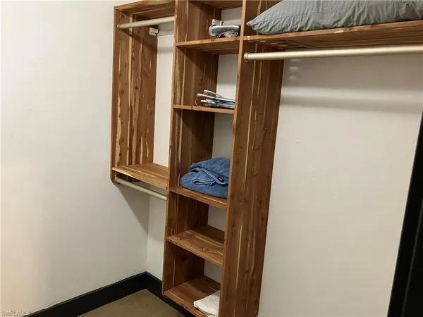 a view of walk in closet with clothes