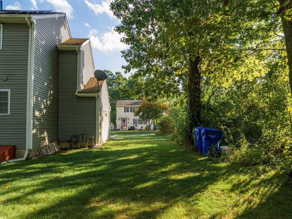 98 Briggs Street Springfield, MA 01151 - Photo 11 of 19 a view of a wooden house with a yard