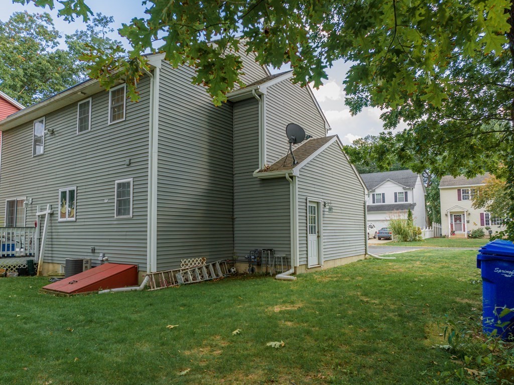 98 Briggs Street Springfield, MA 01151 - Photo 13 of 19 a backyard of a house with table and chairs