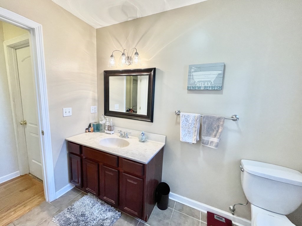 98 Briggs Street Springfield, MA 01151 - Photo 18 of 19 a bathroom with a toilet a sink and mirror