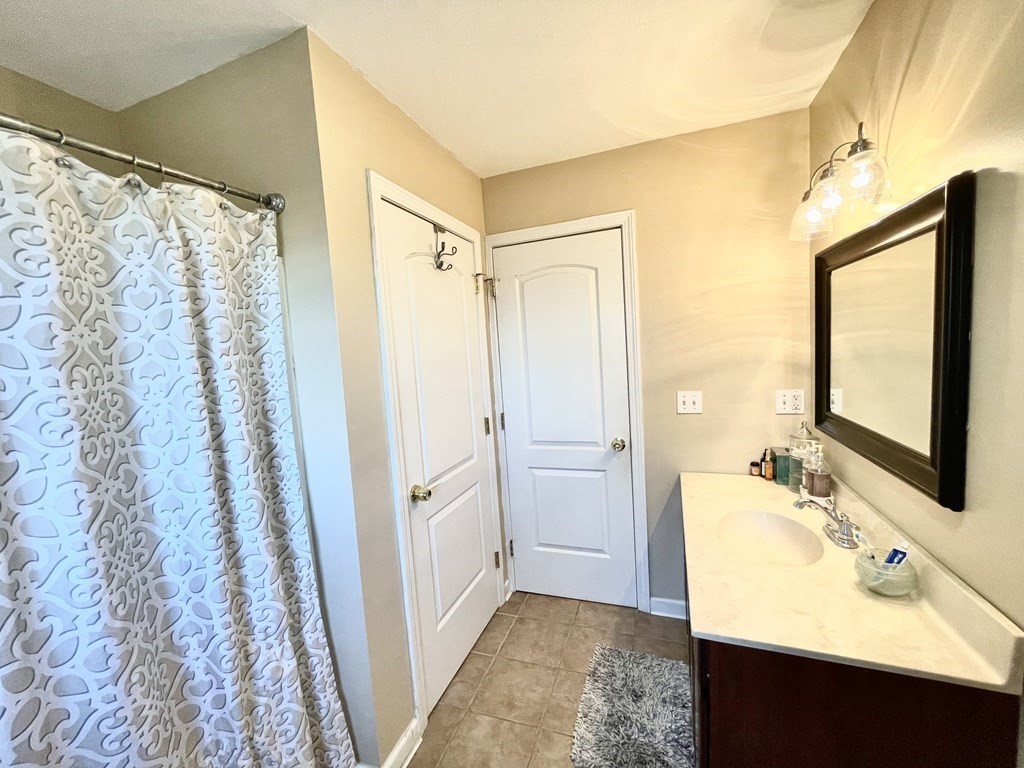 98 Briggs Street Springfield, MA 01151 - Photo 19 of 19 a bathroom with a sink and a mirror