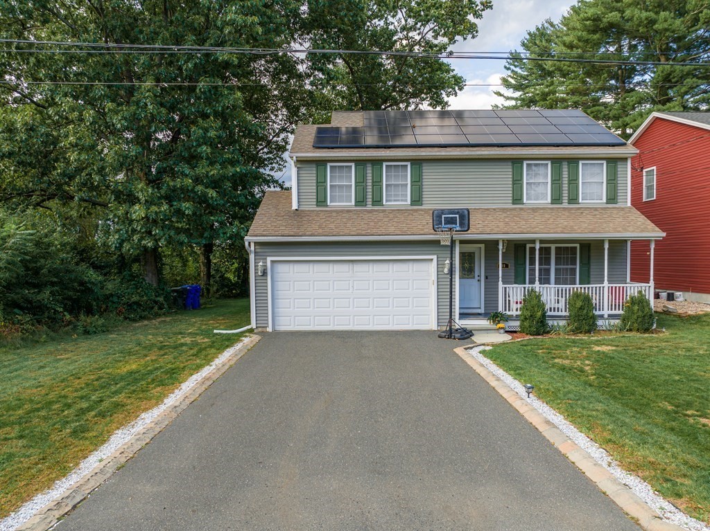 98 Briggs Street Springfield, MA 01151 - Photo 2 of 19 a front view of a house with a garden and yard