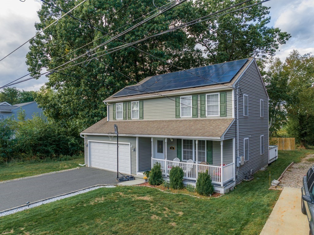 98 Briggs Street Springfield, MA 01151 - Photo 3 of 19 a front view of a house with a garden and yard
