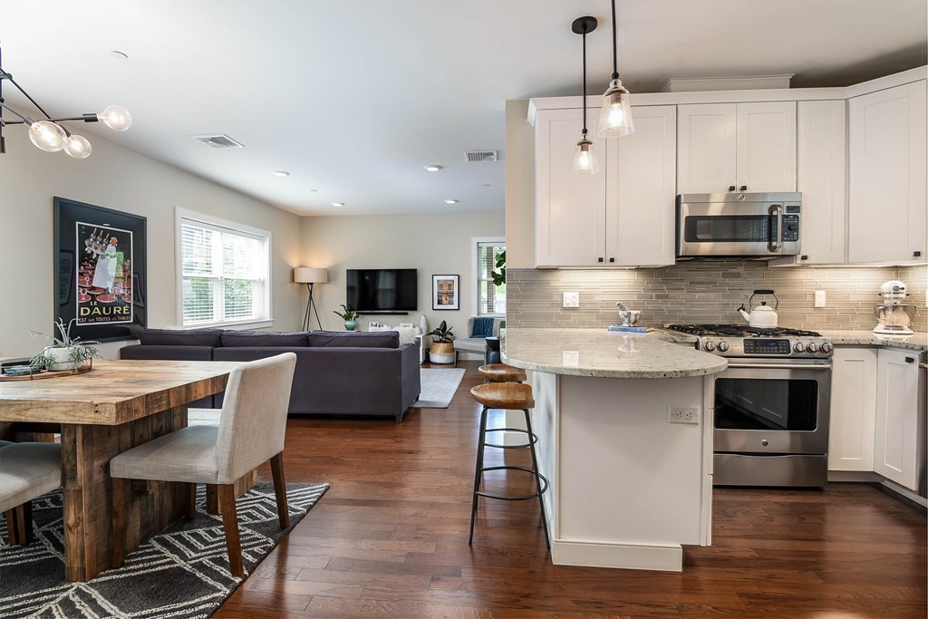 99 Brookley Road, Unit 1 Boston, MA 02130 - Photo 11 of 40 a kitchen with stainless steel appliances a stove a sink a microwave a center island and a refrigerator