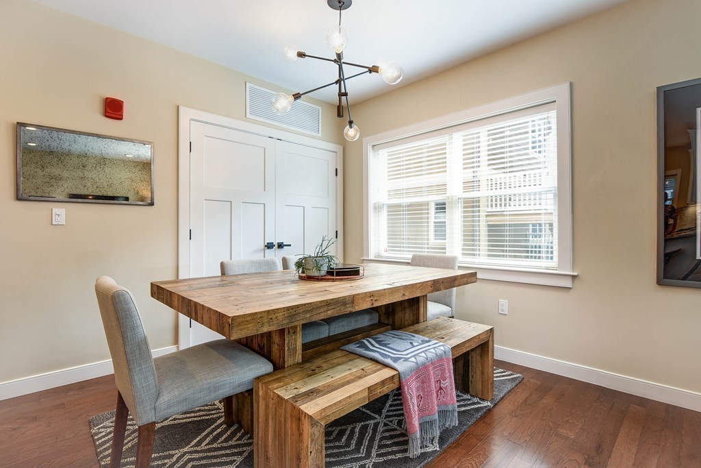 99 Brookley Road, Unit 1 Boston, MA 02130 - Photo 12 of 40 a view of a dining room with furniture window and wooden floor