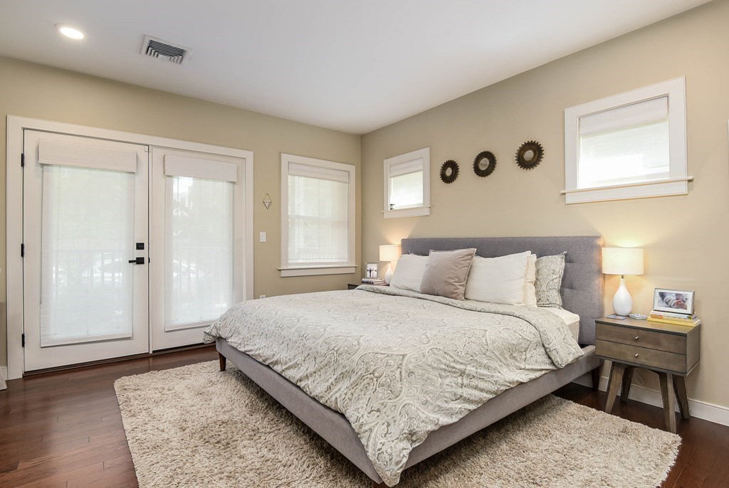 99 Brookley Road, Unit 1 Boston, MA 02130 - Photo 13 of 40 a bedroom with a bed and wooden floor