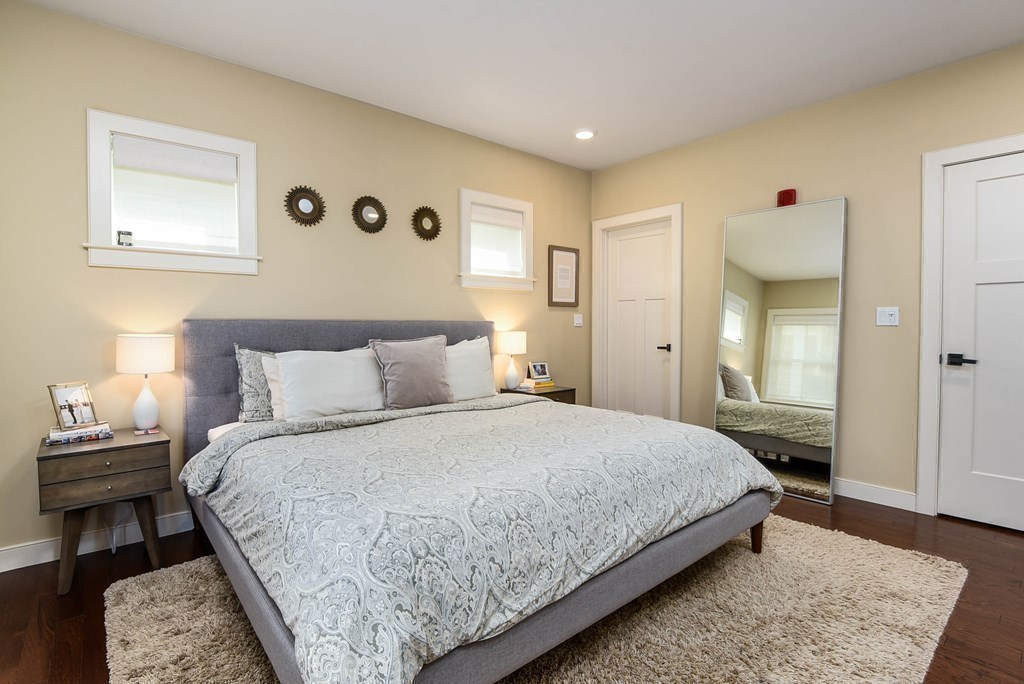 99 Brookley Road, Unit 1 Boston, MA 02130 - Photo 14 of 40 a bedroom with a bed and a lamp