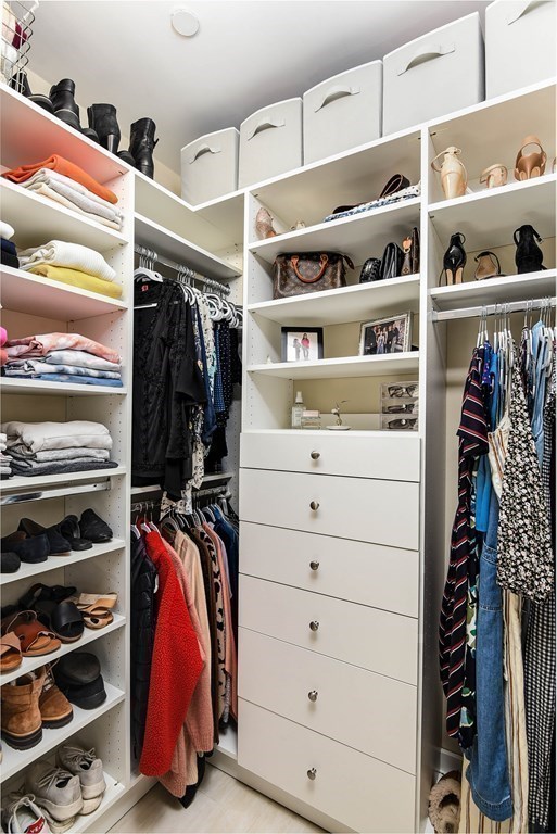 99 Brookley Road, Unit 1 Boston, MA 02130 - Photo 18 of 40 a view of walk in closet with clothes and shoes