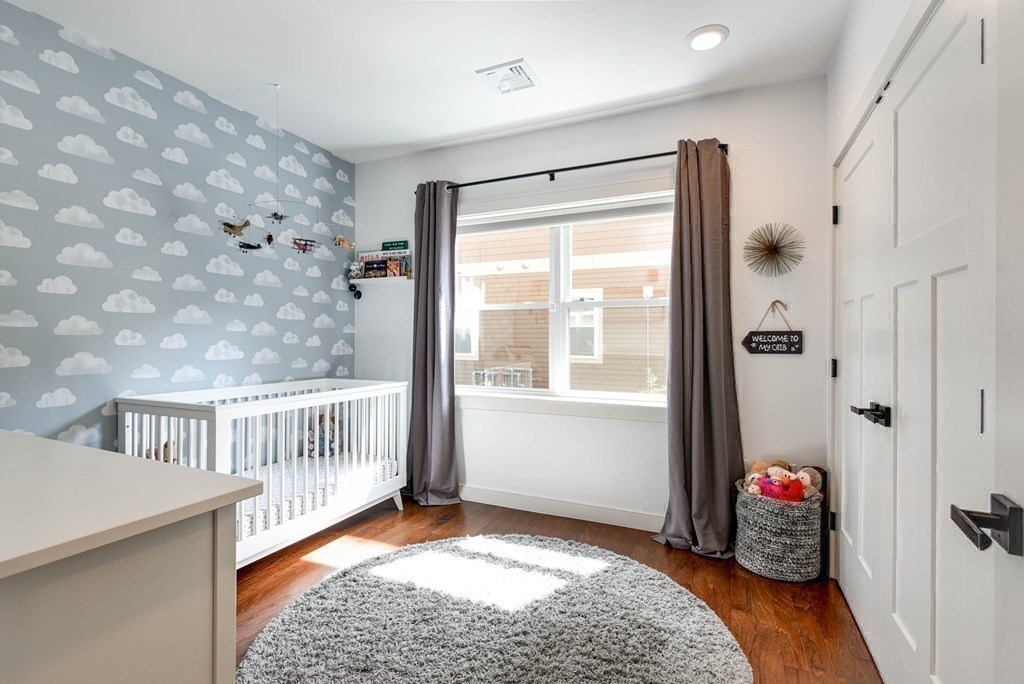99 Brookley Road, Unit 1 Boston, MA 02130 - Photo 21 of 40 a view of an empty room with window and hardwood floor