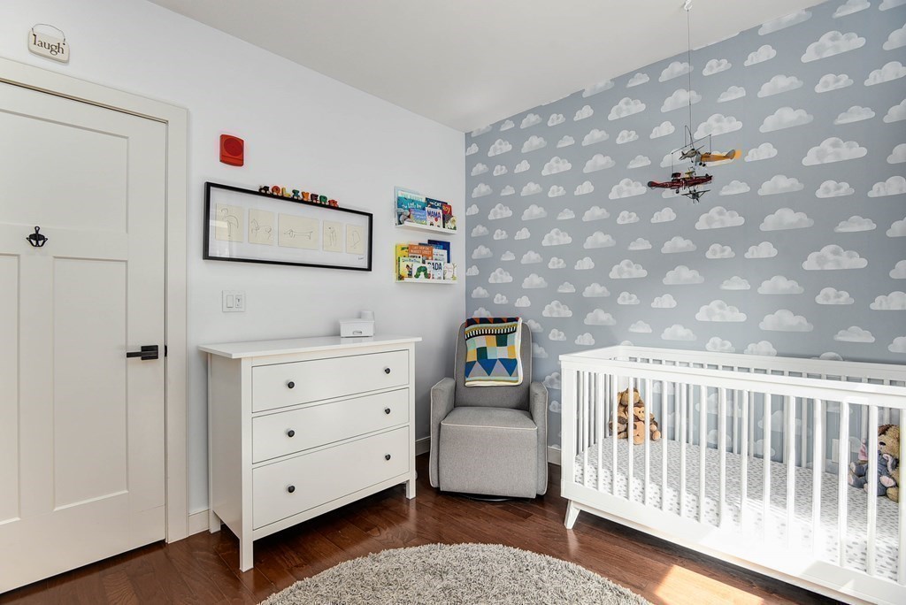 99 Brookley Road, Unit 1 Boston, MA 02130 - Photo 22 of 40 a bedroom with a bed and a dresser