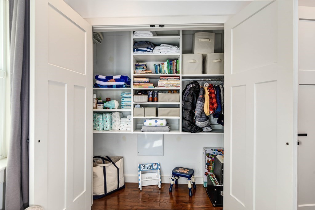 99 Brookley Road, Unit 1 Boston, MA 02130 - Photo 23 of 40 a view of walk in closet with clothes and shoes