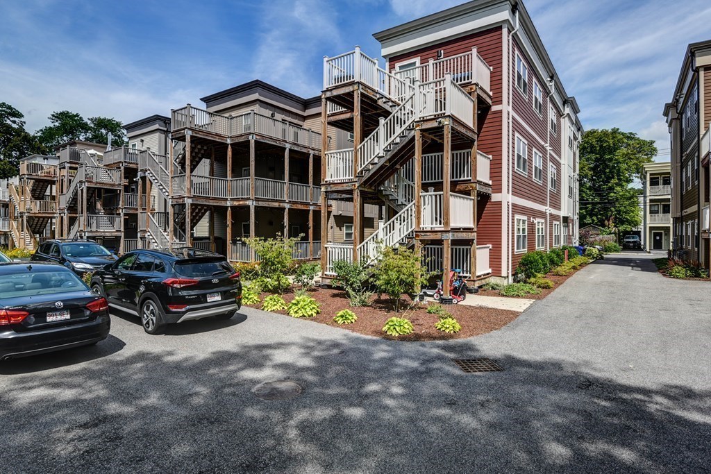 99 Brookley Road, Unit 1 Boston, MA 02130 - Photo 29 of 40 a car parked in front of a white house