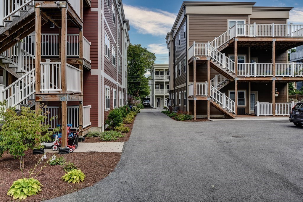 99 Brookley Road, Unit 1 Boston, MA 02130 - Photo 31 of 40 a front view of a building with street