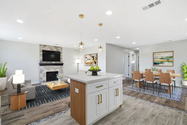 a living room with furniture and kitchen view