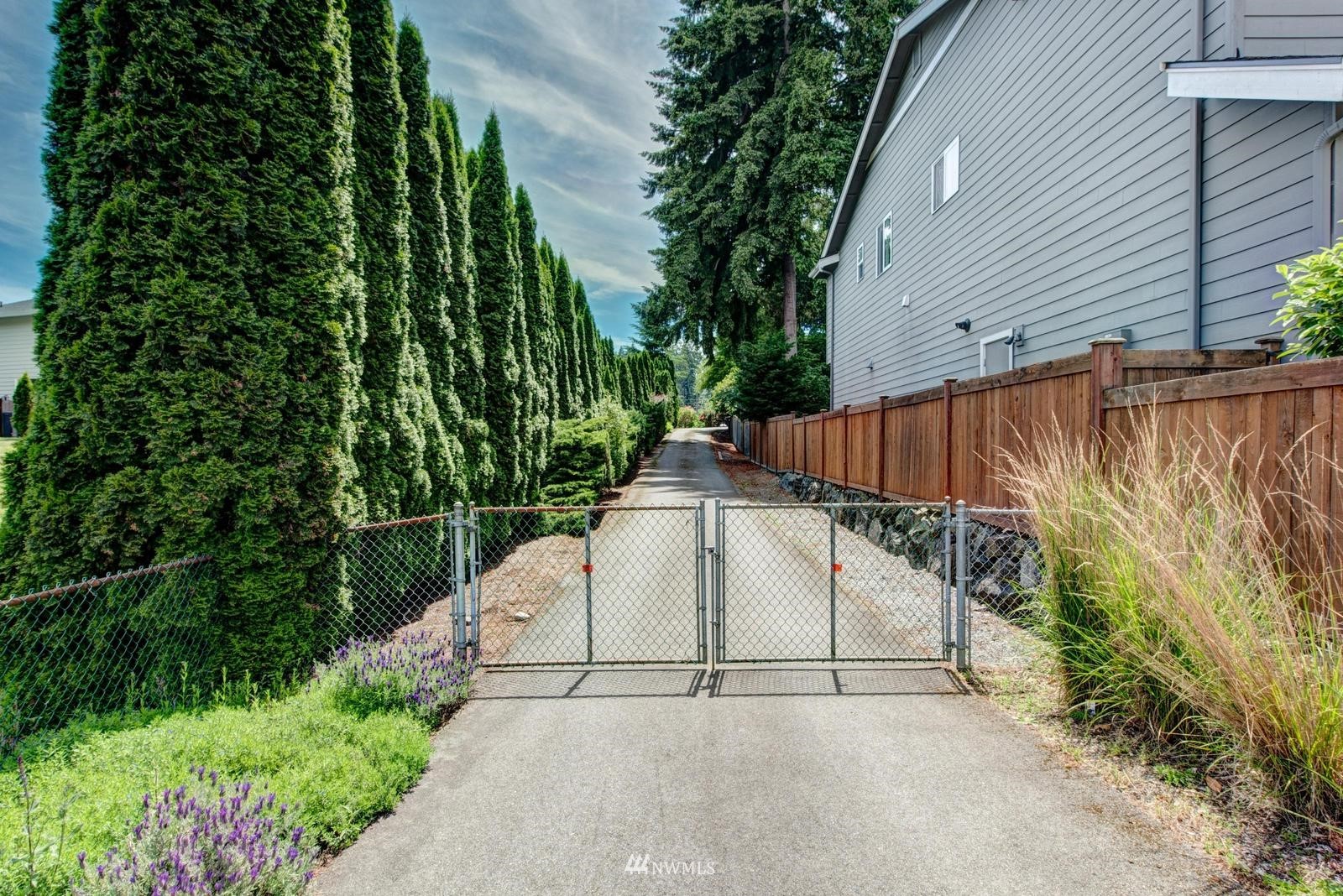 9325 Northeast 175th Street Bothell, WA 98011 - Photo 7 of 19 a white house with green field in front of it