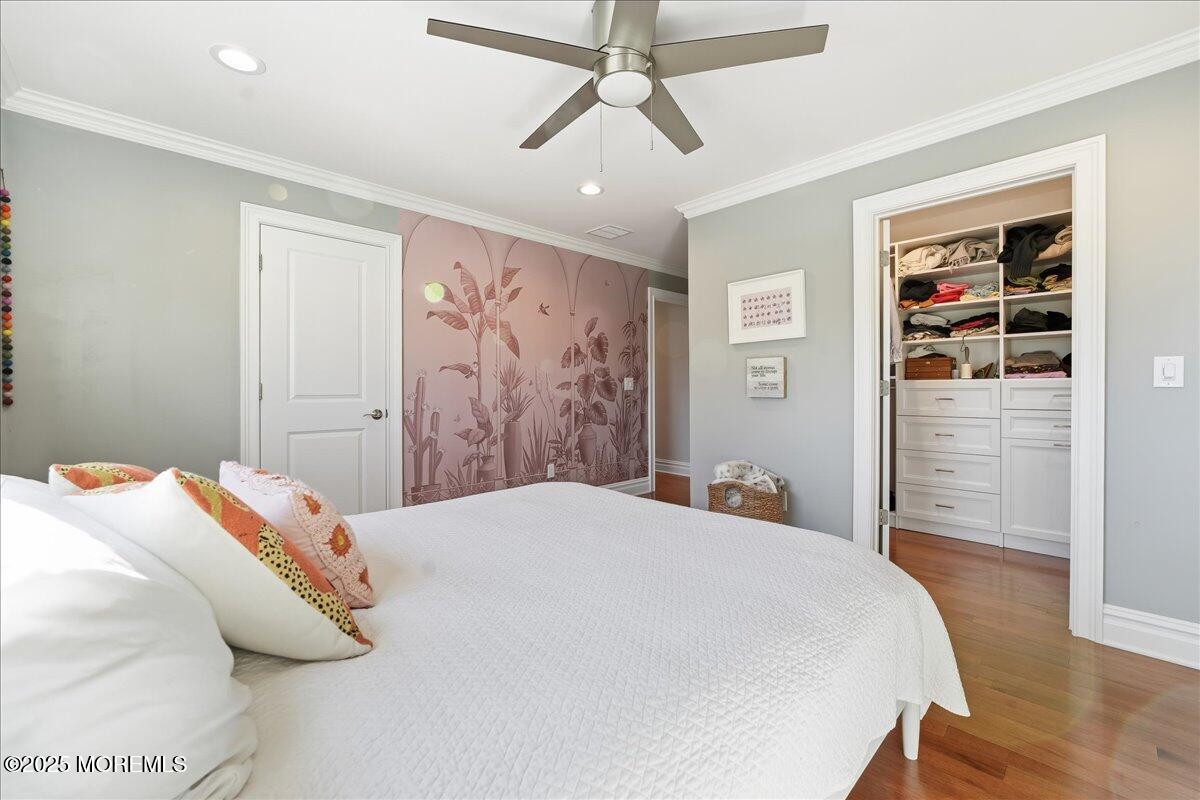 26 Ralph Street Highlands, NJ 07732 - Photo 19 of 51 a bedroom with a large bed and a chandelier