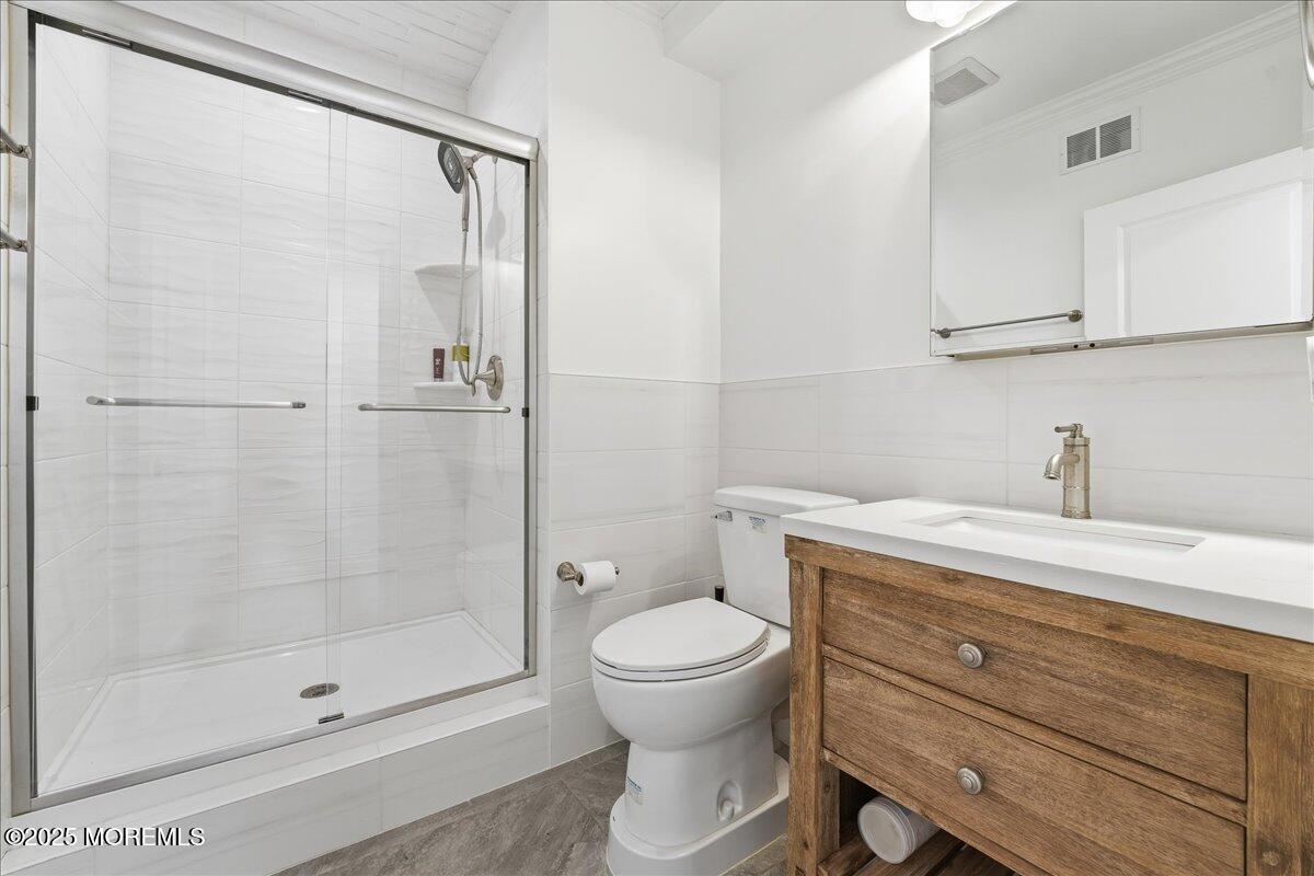 26 Ralph Street Highlands, NJ 07732 - Photo 29 of 51 a bathroom with a granite countertop sink a toilet and shower