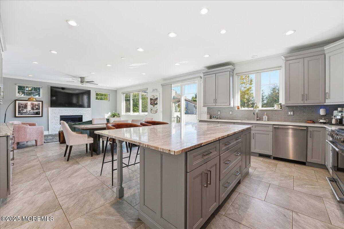 26 Ralph Street Highlands, NJ 07732 - Photo 3 of 51 a kitchen with kitchen island granite countertop a sink counter top space appliances and a window