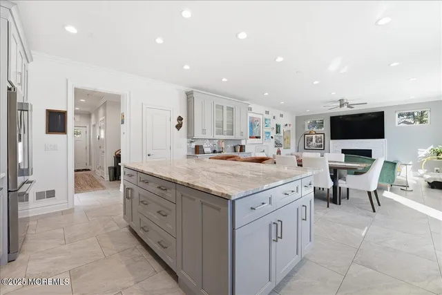 a spacious kitchen with stainless steel appliances granite countertop a large counter top and a stove