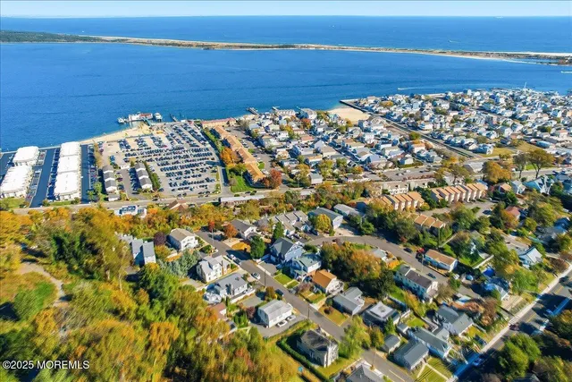 an aerial view of multiple houses with yard