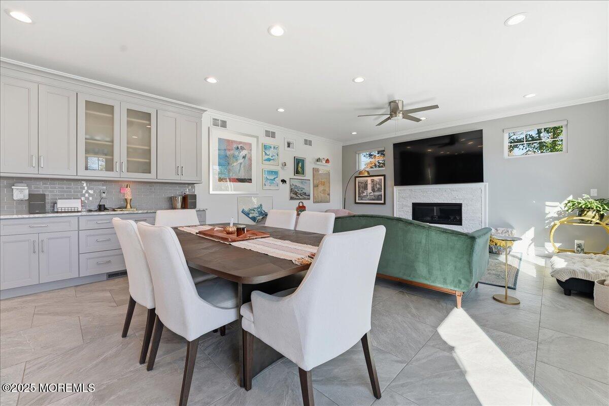 26 Ralph Street Highlands, NJ 07732 - Photo 7 of 51 a view of a dining room with furniture a fireplace and wooden floor