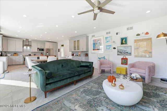 a living room with furniture and a view of kitchen