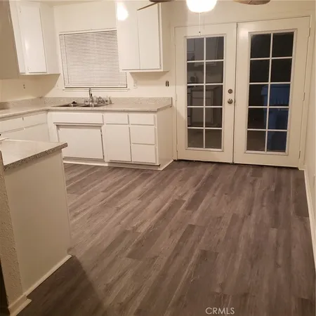 a white stove top oven sitting inside of a kitchen