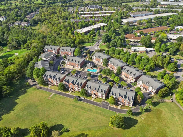 an aerial view of a house with a garden and lake view