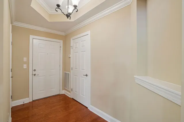 a view of a hallway with a chandelier fan