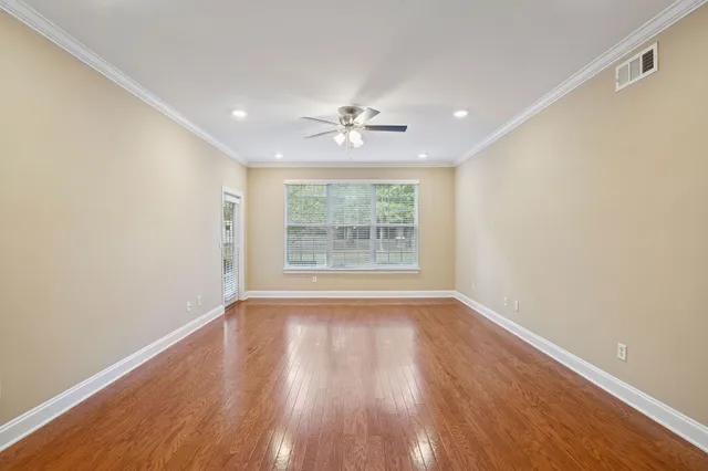 wooden floor in an empty room with a window