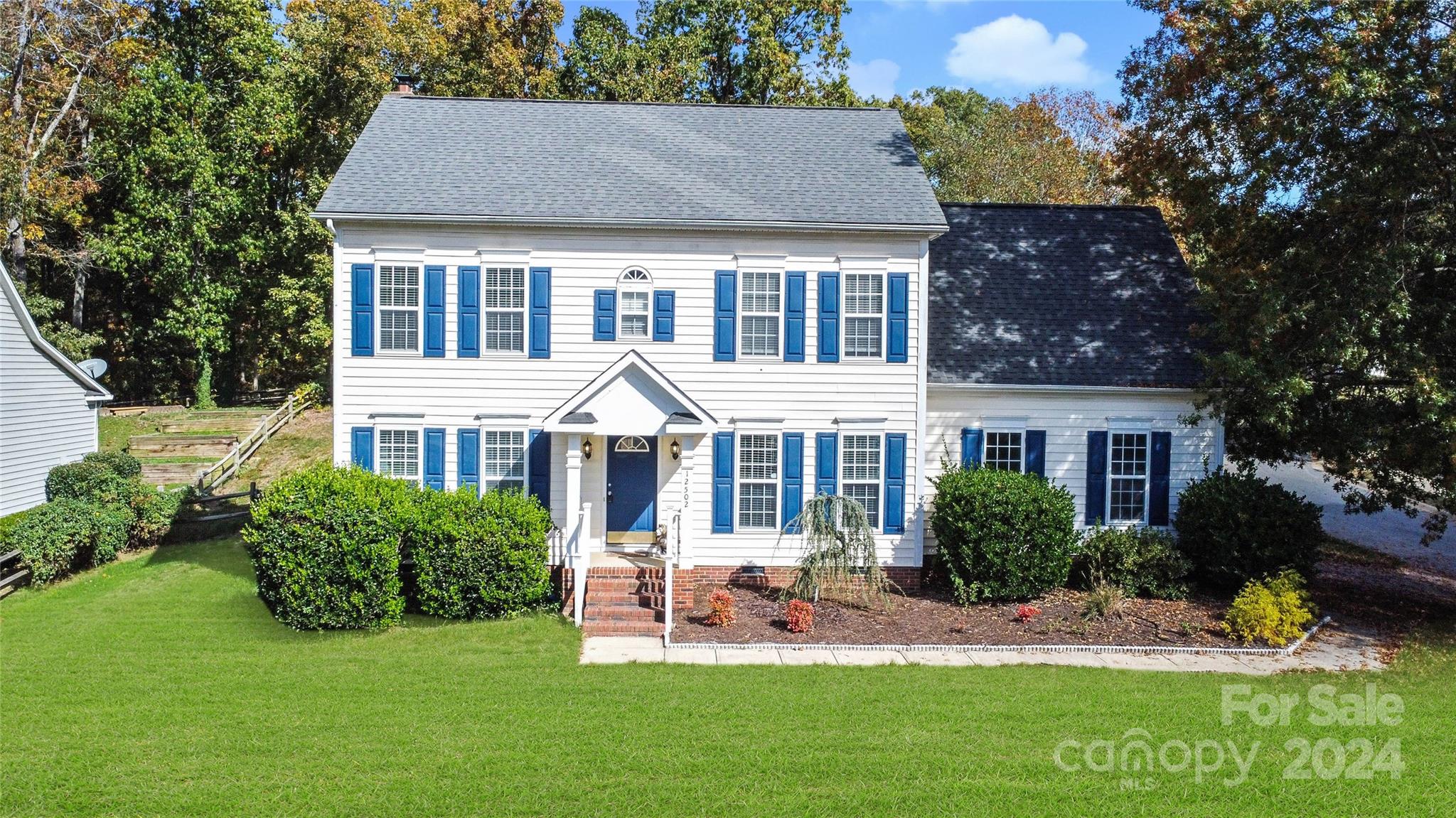 12502 Chickasaw Drive Huntersville, NC 28078 - Photo 1 of 39 a front view of a house with a yard table and chairs