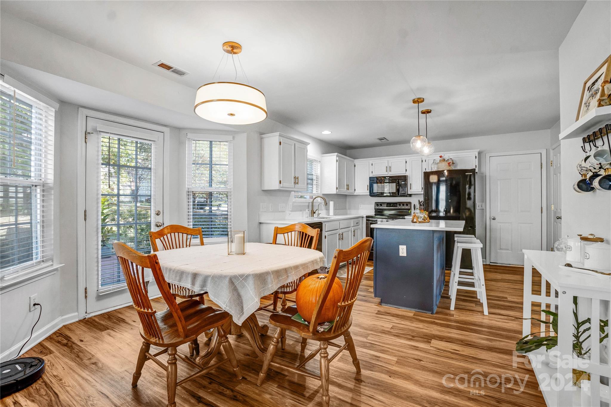 12502 Chickasaw Drive Huntersville, NC 28078 - Photo 12 of 39 a view of a dining room with furniture and a chandelier