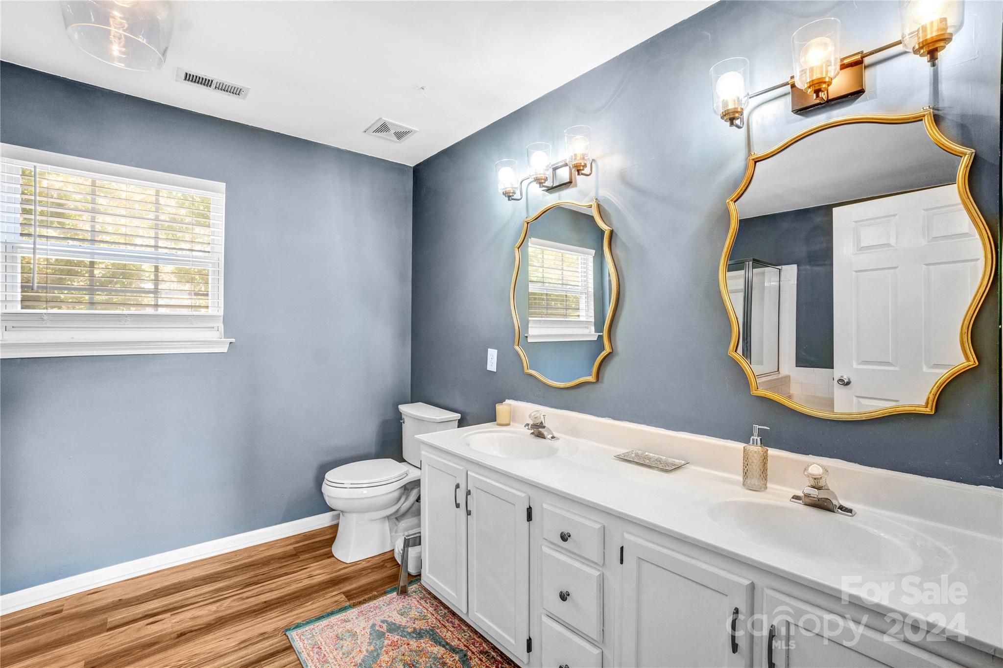 12502 Chickasaw Drive Huntersville, NC 28078 - Photo 19 of 39 a bathroom with a double vanity sink mirror and toilet