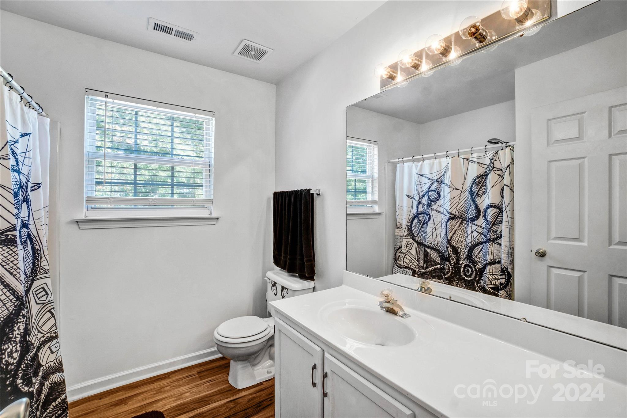 12502 Chickasaw Drive Huntersville, NC 28078 - Photo 24 of 39 a bathroom with a granite countertop toilet sink and mirror