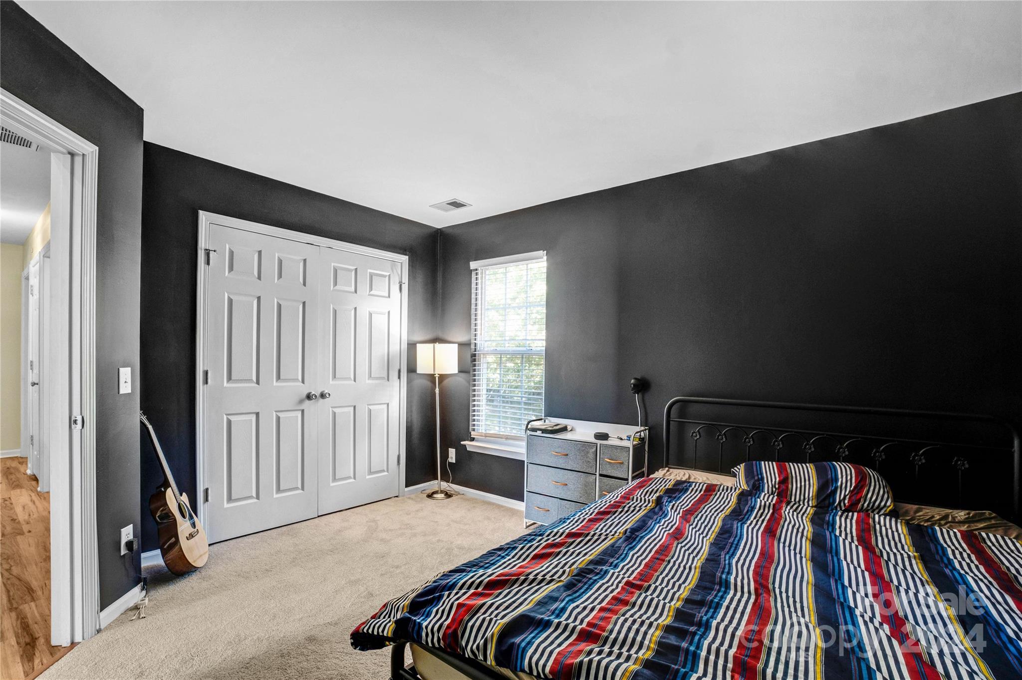 12502 Chickasaw Drive Huntersville, NC 28078 - Photo 29 of 39 a bedroom with a bed and a book shelf