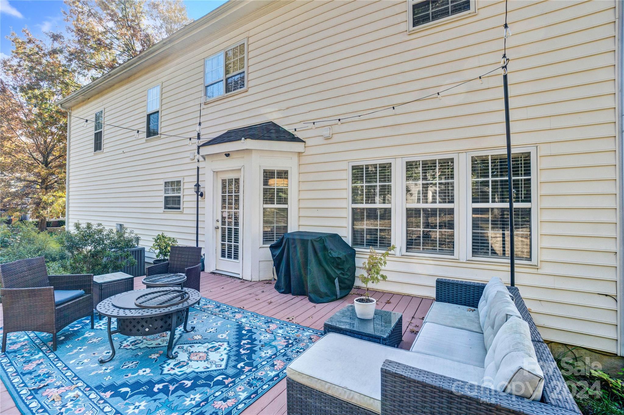12502 Chickasaw Drive Huntersville, NC 28078 - Photo 30 of 39 a view of a patio with couches chairs and potted plants