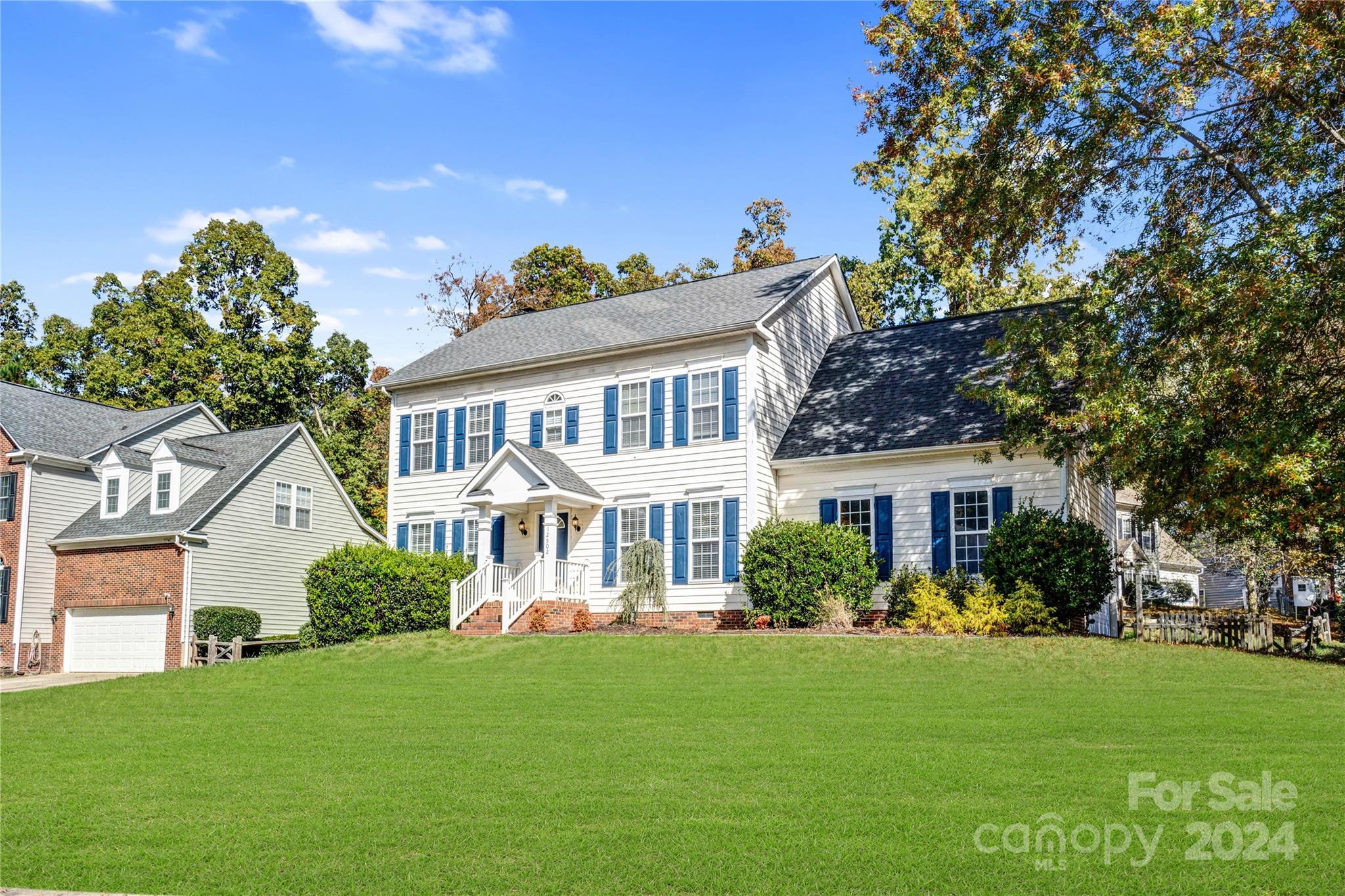 12502 Chickasaw Drive Huntersville, NC 28078 - Photo 3 of 39 a front view of a house with a garden