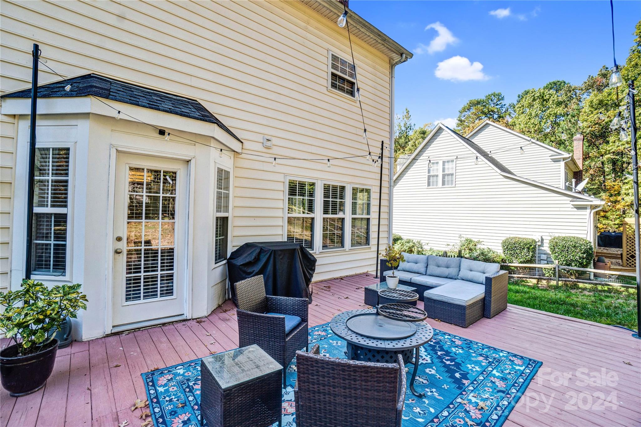 12502 Chickasaw Drive Huntersville, NC 28078 - Photo 31 of 39 a view of a patio with couches table and chairs and potted plants