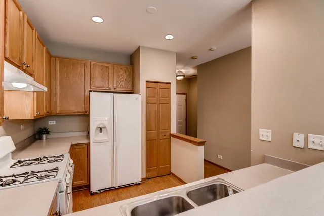 a kitchen with stainless steel appliances a refrigerator and a stove top oven