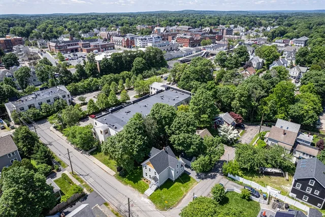 an aerial view of residential houses with outdoor space and street view