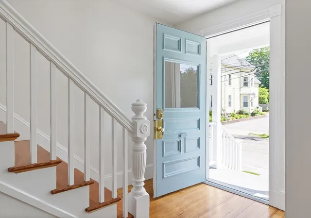 a view of entryway with wooden floor and door